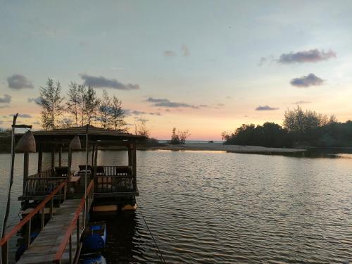 a dock on a body of water at sunset at Eco Lagoon in Phu Quoc