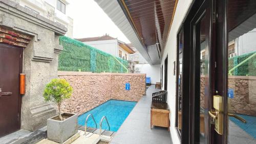 a building with a swimming pool painted on the side of it at The Tandibayang Hotel & Villas in Badung