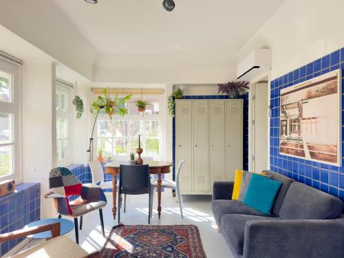 a living room with a couch and a table at Apartment in former Bathhouse in Amsterdam