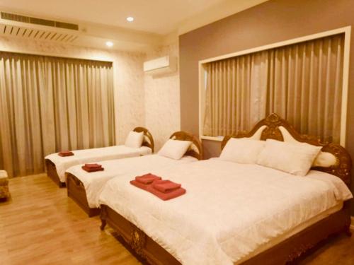 a bedroom with two beds with towels on them at Na Khwae Villa Riverside in Nong Bua