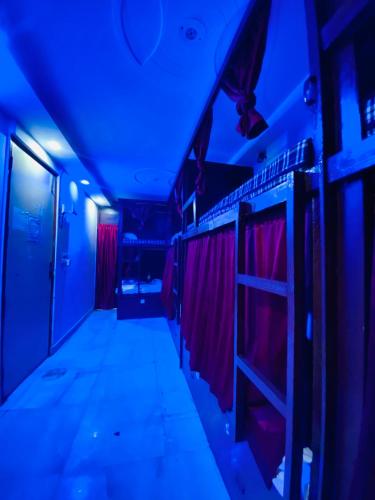 a dark room with red and blue lights at Cozy Inn Hostel in New Delhi