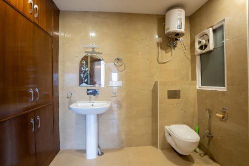 a bathroom with a sink and a toilet at Hotel Yog Ganga Retreat in Rishīkesh