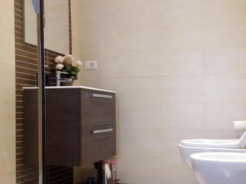a bathroom with a toilet and a sink at The Pope At The Window in Rome