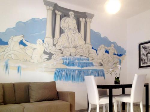 a living room with a mural of a fountain at The Pope At The Window in Rome