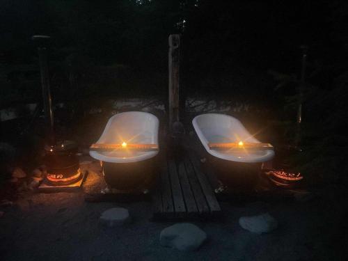two toilets are lit up in the dark at Hut on The Grove in Twizel