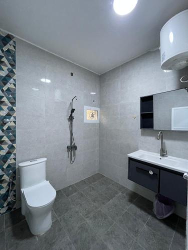 a bathroom with a toilet and a sink at Samail Valley in Samail