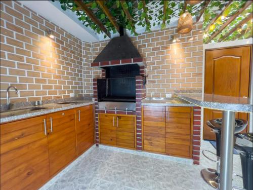 a kitchen with a brick wall and an oven at Modern, Luxurious and Tradicional Apartments by Samilis Place in Cali