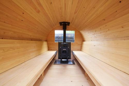 a inside of a sauna with a stove in it at 高尾山すぐ貸切villa都心から70分自然豊か貸切サウナ道志ツーリングBBQ焚火花火日本庭園 in Sagamihara