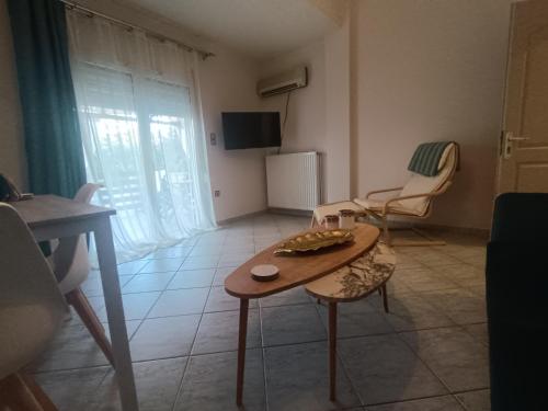 a small living room with a table and chairs at Salamina Azuro in Selínia