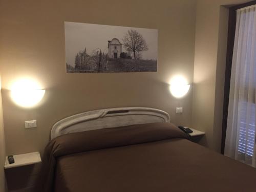 Postel nebo postele na pokoji v ubytování Hotel Ciocca