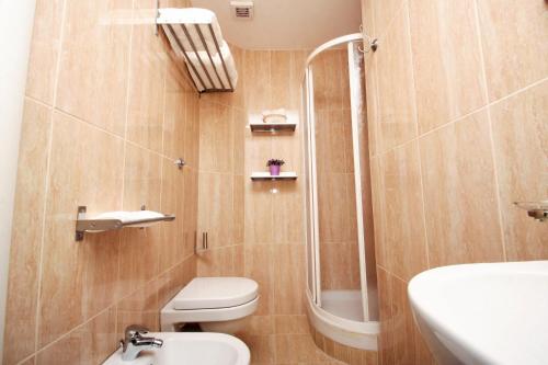 a bathroom with a toilet and a shower and a sink at Camere Ondina in Rome