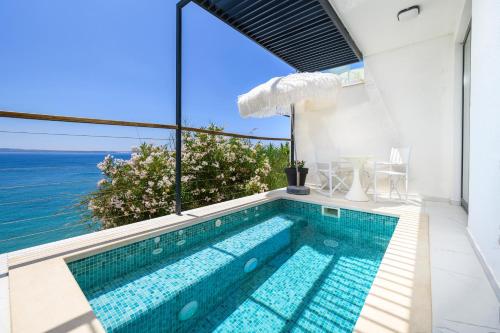 a swimming pool with a view of the ocean at Gallery Luxury Suites & Rooms-Only Adults in Split