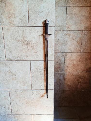 a sword hanging on a wall at Le Mirage in Chieti