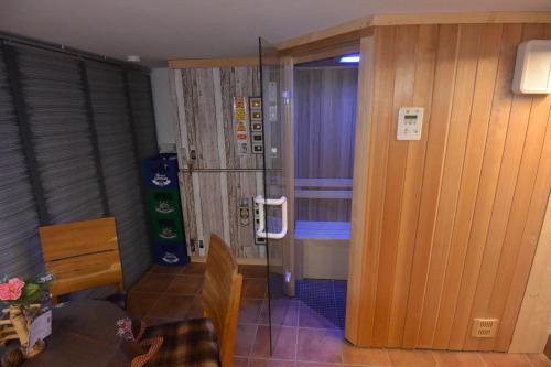 a room with a glass door leading to a bathroom at Haus Erli in Mittenwald