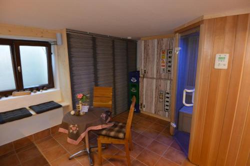 a dining room with a table and chairs and a window at Haus Erli in Mittenwald
