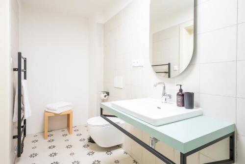 a bathroom with a sink and a toilet at Zámek Načeradec in Načeradec
