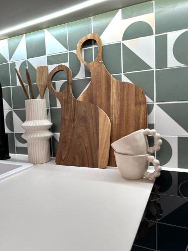 a kitchen counter with wooden utensils on a counter top at Studio Cosy - Centre-ville in Brest