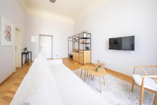 a living room with white walls and a large couch at Zámek Načeradec in Načeradec