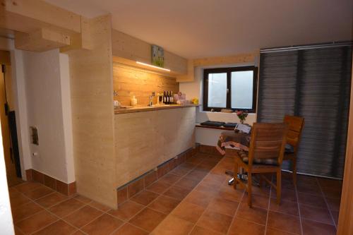 a kitchen with a counter and a table and chairs at Haus Erli in Mittenwald