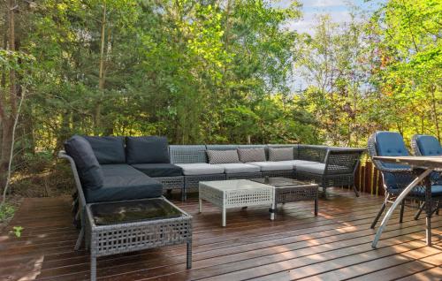 a patio with a couch and chairs on a deck at Lovely Home In Hurup Thy in Sønder Ydby