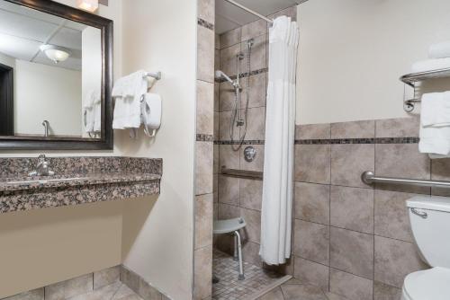 a bathroom with a shower and a toilet at Baymont by Wyndham Bloomington MSP Airport in Richfield