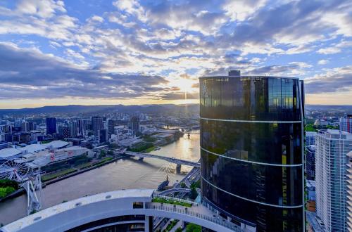 a view of a city with a tall building at River Glow at Queens Wharf Level 43 in Brisbane