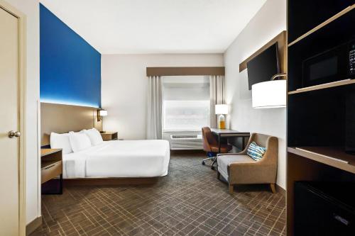 a hotel room with a bed and a desk at Comfort Inn & Suites O'Fallon - St Louis Area in O'Fallon