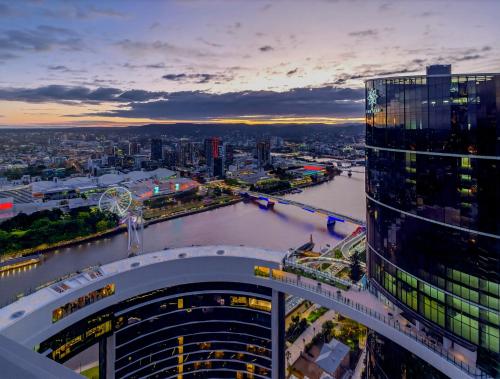 an aerial view of a city and a river at River Glow at Queens Wharf Level 43 in Brisbane
