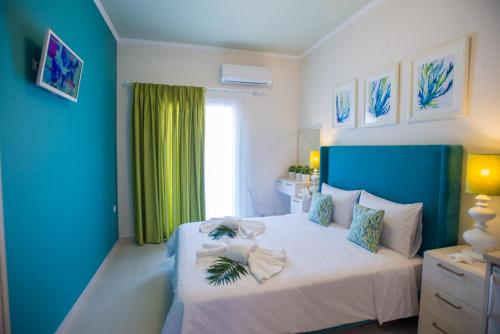 a bedroom with a large bed with a blue wall at Mansion House Parga in Parga