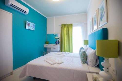 a blue bedroom with a bed and a window at Mansion House Parga in Parga