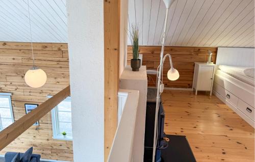 a room with wooden walls and a bed and two lights at Lovely Home In Gränna With Lake View in Gränna