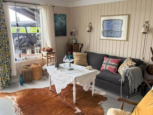a living room with a couch and a table at 8 person holiday home in frosta in Vollen