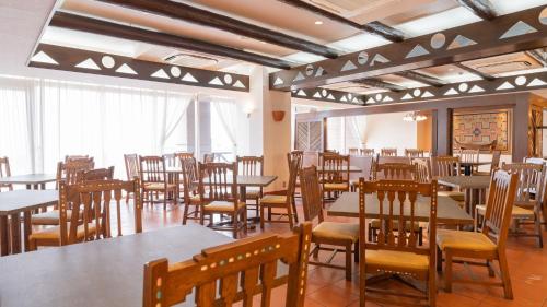 a dining room filled with tables and chairs at Hotel Atollemerald Miyakojima in Miyako Island