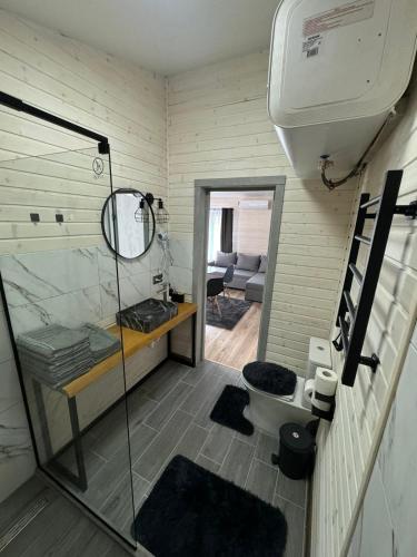 a small bathroom with a shower and a toilet at OLENEVO Park Houses in Olenʼovo