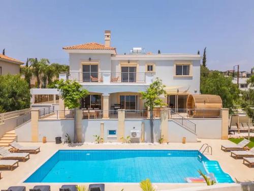 a large house with a swimming pool in front of it at Luxury Seaview Limassol Villa Pool Jacuzzi Sauna in Limassol