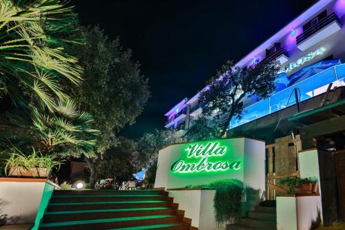 a sign in front of a building at night at Hotel Villa Ombrosa in Portoferraio
