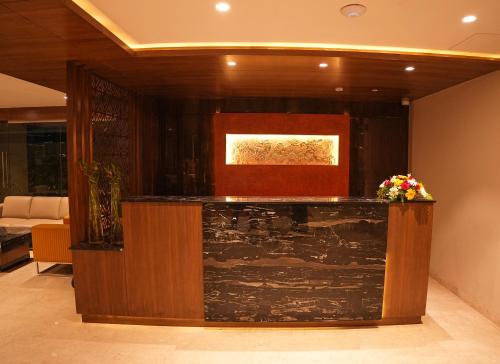 a lobby with a counter with flowers on it at M Central in Chennai