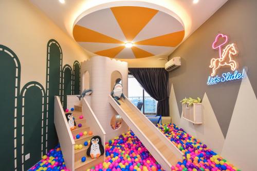 a room with a play room with a slide and balls at Country Garden Seaview Suite by Nest Home at Danga Bay in Johor Bahru