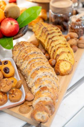 a tray of food with bread and nuts on a table at Le Petit Hôtel in Saint-Jean-de-Luz
