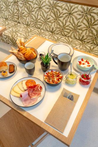a table with a tray of food on it at Le Petit Hôtel in Saint-Jean-de-Luz