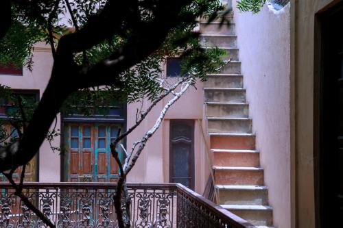a set of stairs next to a building with a door at Neem Haveli in New Delhi