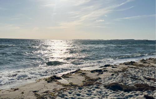 a beach with the ocean and the shoreline at Gorgeous Home In Karrebæksminde in Karrebæksminde