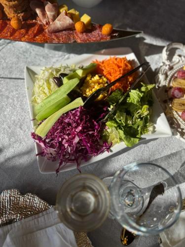 a plate of food with vegetables on a table at Complex Praga in Gorno Lakočerej