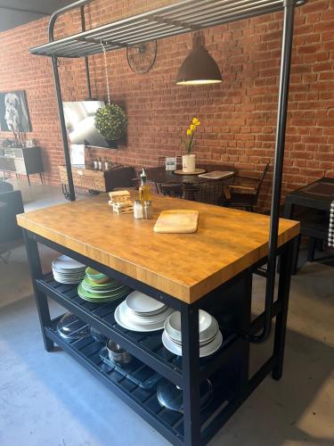 a table with plates on it in a room at Industrial Cozy Gzira Apt, Prime Spot, Sep Deal in Il-Gżira