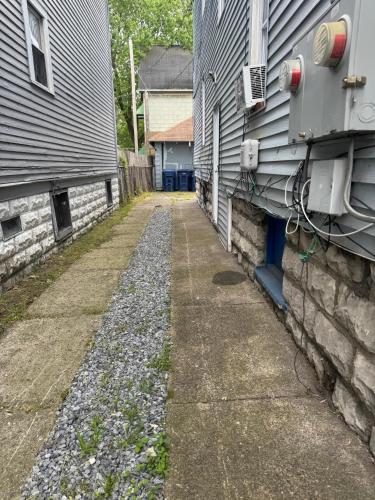 an alley between two buildings next to a house at Charming 2-bedroom apartment with WiFi, fitness room in delightful Buffalo in Buffalo
