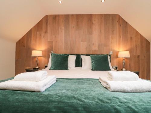 a large bed with two white pillows on it at Clematis Cottage in Whitby