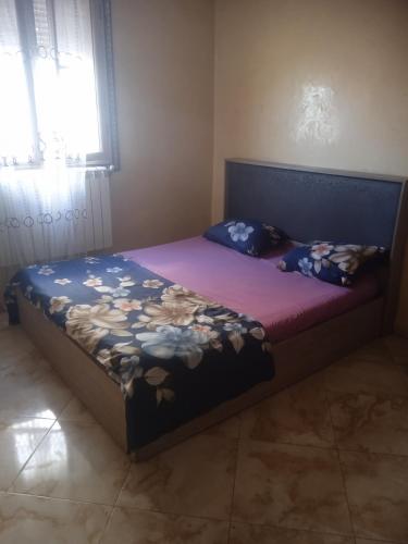a bedroom with a bed with a purple blanket at Home sweet home 2 bed with a living room in Batna