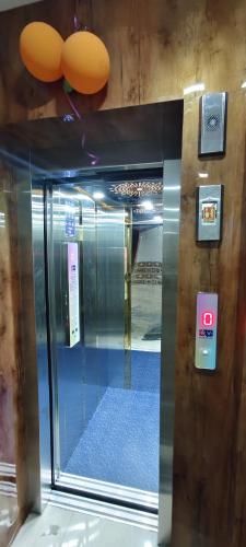 a glass door of an elevator in a building at Sri Vinayaga Residency in Rāmeswaram