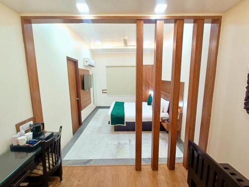 a view of a room with a bed and a desk at Hotel Sun Grand in Agra
