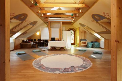 a large room with a table and a rug on the floor at Biolandhaus Arche in Eberstein